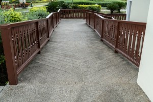 Concrete ramp for wheelchair with wooden railing